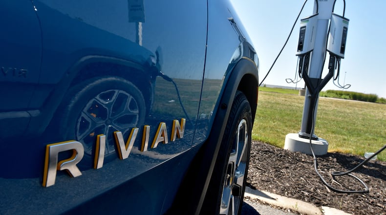 The Rivian R1T electric vehicle is connected to a charging station outside the Rivian Plant in Normal, Ill., on July 20, 2022. (Photo for the Atlanta Journal Constitution by Ron Johnson)