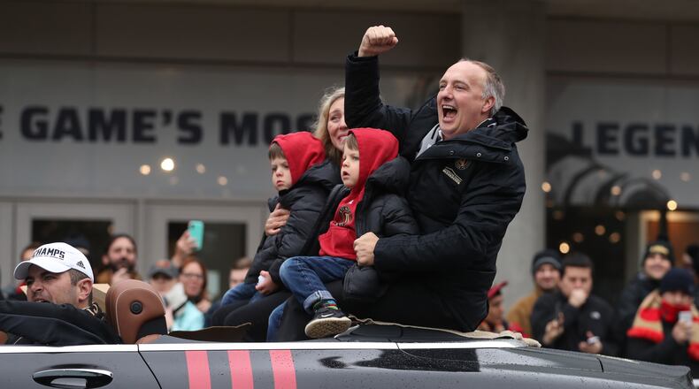 December 10, 2018 - Atlanta, Ga: Atlanta United President Darren Eales celebrates with fans as he rides with his family during the Atlanta United MLS Cup victory parade along Marietta Street Monday, December 10, 2018, in Atlanta. (JASON GETZ/SPECIAL TO THE AJC)