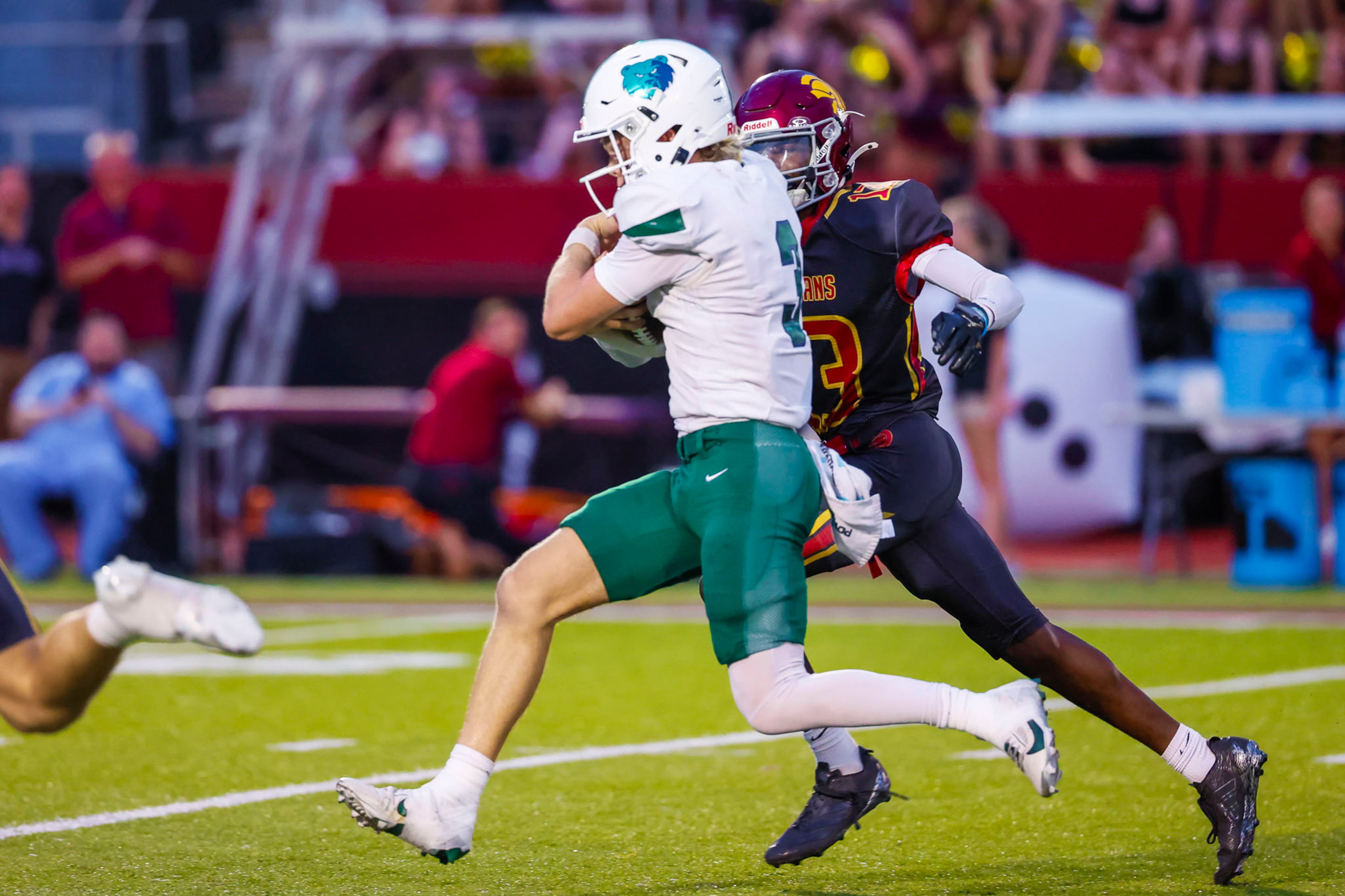 Creekview quarterback Alex Penrod (front) attempts a run against Lassiter High School on Friday, Sept. 5, 2025, in Marietta. (Oscar Guevara Saenz for the AJC)
