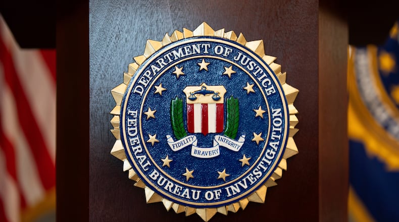 FILE - An FBI seal is displayed on a podium before a news conference at the field office in Portland, Ore., Jan. 16, 2025. (AP Photo/Jenny Kane, File)