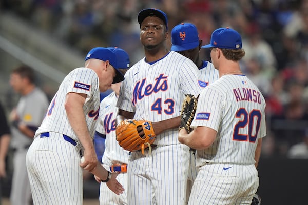 New York Mets manager Carlos Mendoza takes the ball from New York Mets pitcher Huascar Brazobán during the sixth inning of a baseball game against the Atlanta Braves Tuesday, June 24, 2025, in New York. (AP Photo/Frank Franklin II)