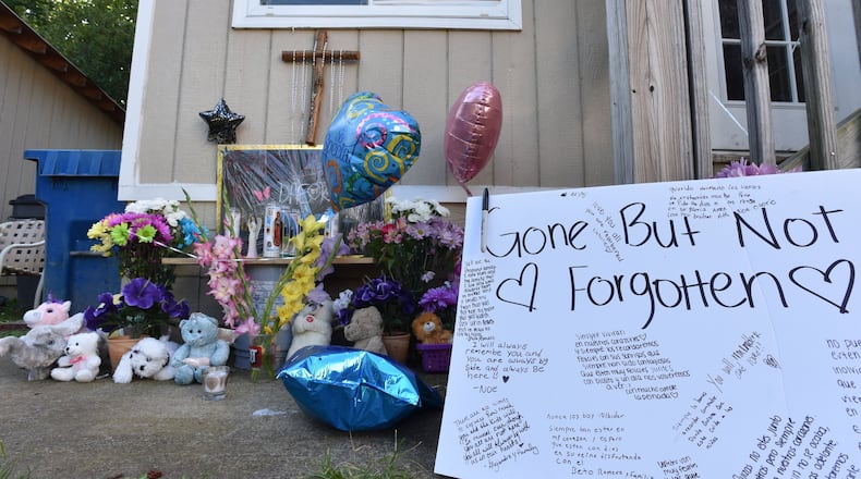 July 7, 2017 Loganville - Neighbors and friends placed flowers and messages Wednesday night during their gathering on the doorstep of a home where four children and their father were stabbed to death in Loganville on Friday, July 7, 2017. Gwinnett County mother Isabel Martinez was charged with multiple counts of murder in the stabbing deaths of four of her children and their father, law enforcement said. HYOSUB SHIN / HSHIN@AJC.COM
