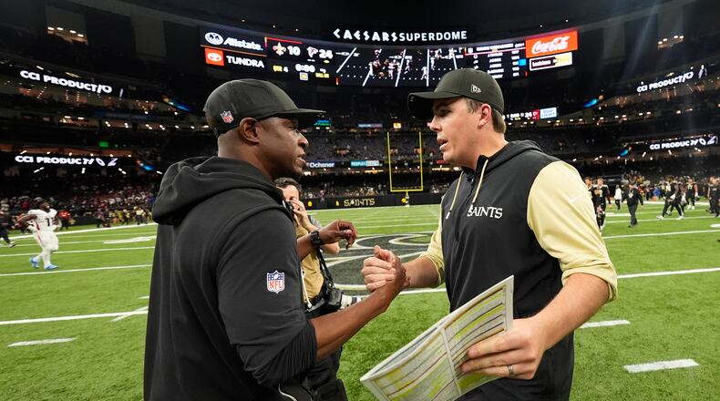 Atlanta Falcons head coach Raheem Morris (left) and New Orleans Saints head coach Kellen Moore shake hands after an NFL football game, Sunday, Nov. 23, 2025, in New Orleans. (Gerald Herbert/AP)