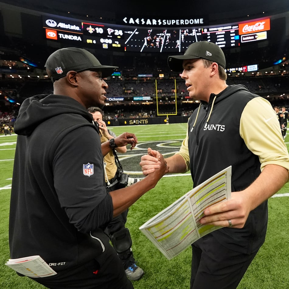Atlanta Falcons head coach Raheem Morris (left) and New Orleans Saints head coach Kellen Moore shake hands after an NFL football game, Sunday, Nov. 23, 2025, in New Orleans. (Gerald Herbert/AP)