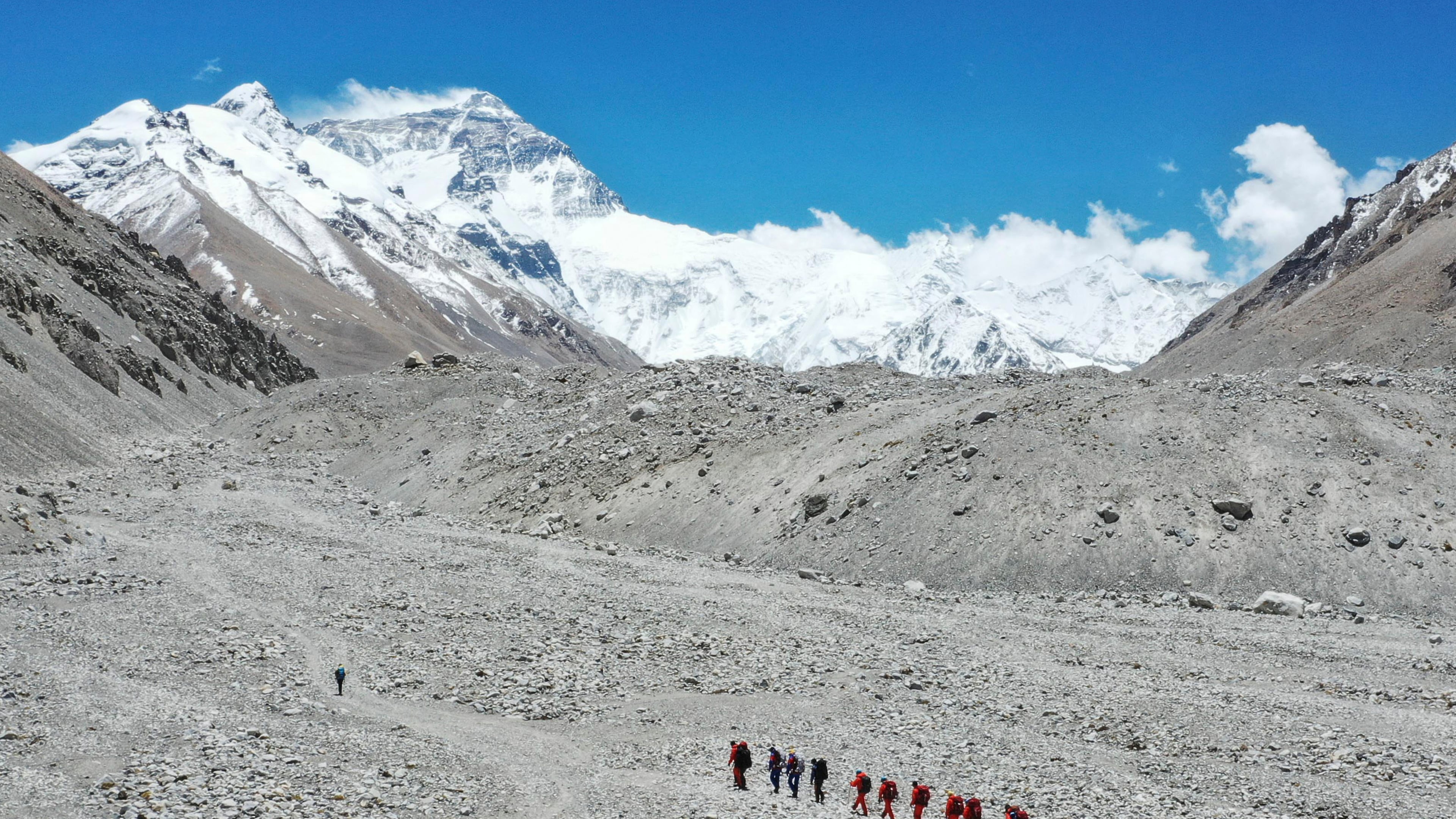 FILE - In this May 16, 2020 aerial photo released by Xinhua News Agency, Chinese surveyors hike toward a higher spot from the base camp on Mount Qomolangma at an altitude of 5,200 meters. (Jigme Dorje/Xinhua via AP, File)