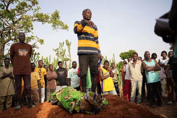 People attend the funeral of a man that was killed following an attack by gunmen in the Zike farming community in north-central Nigeria, Tuesday, April 15, 2025. (AP Photo/Samson Omale)