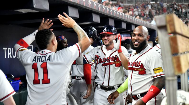 Atlanta Braves players celebrate in the dugout after Matt Olson and Forrest Wall scored on an error in the bottom of the eighth inning Tuesday. (Hyosub Shin / Hyosub.Shin@ajc.com)