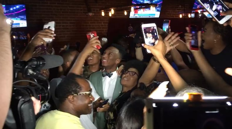 Former Georgia Tech guard Josh Okogie celebrates with family and friends Thursday night after he was selected in the first round of the NBA draft by the Minnesota Timberwolves. (Image captured from video)