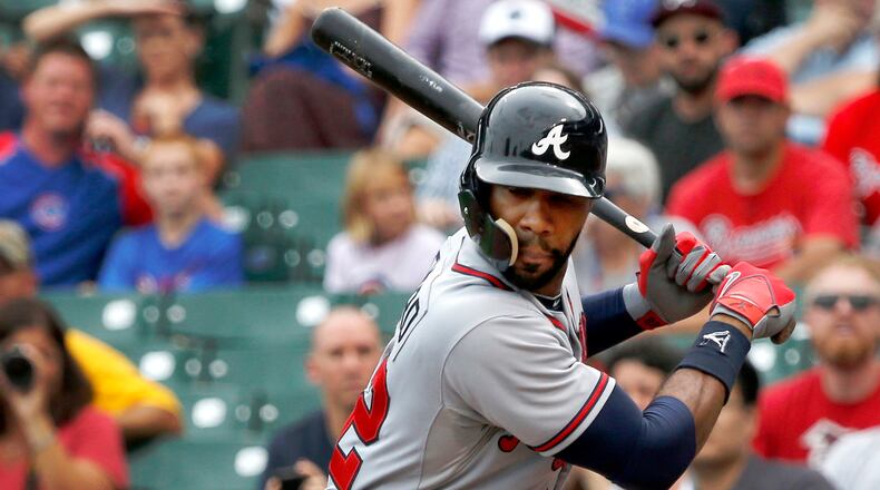 Atlanta Braves' Jason Heyward, wearing a protective shield for his face, waits for a pitch by Chicago Cubs starter Scott Baker during the first inning of a baseball game Friday, Sept. 20, 2013, in Chicago. (AP Photo/Charles Rex Arbogast)