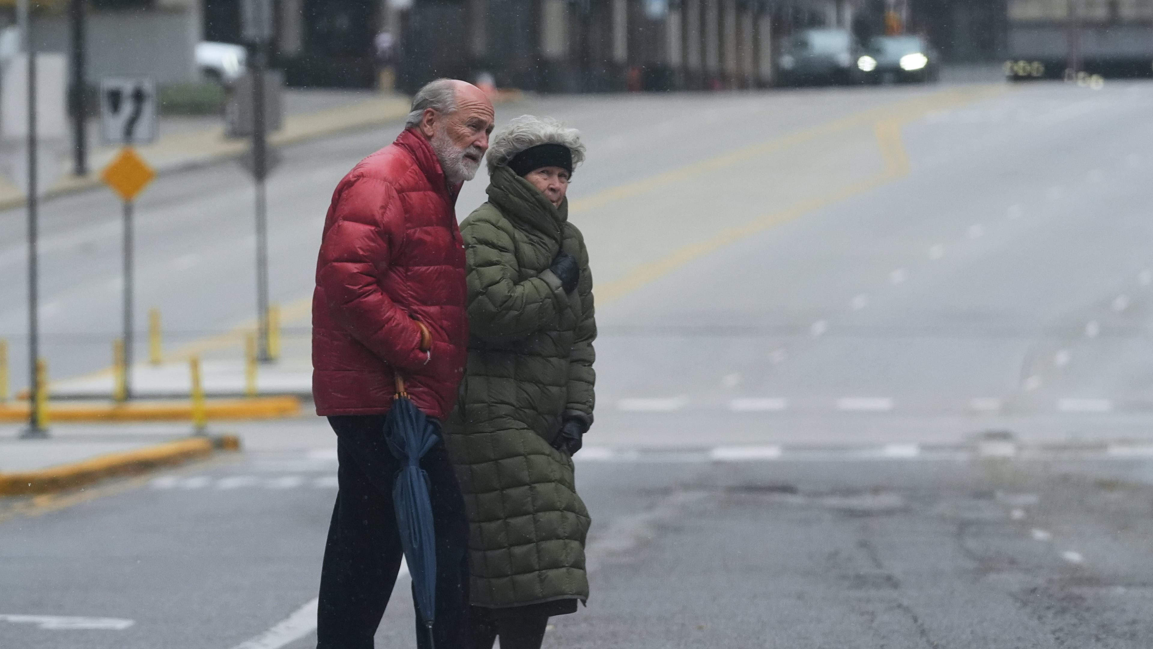 Pedestrians cross a street during a cold day in Chicago, Sunday, Nov. 9, 2025. (AP Photo/Nam Y. Huh)