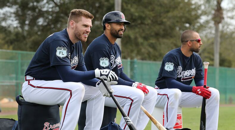 The Braves’ Freddie Freeman (from left), Matt Kemp and Nick Markakis wait their turns in batting practice at spring training. (Curtis Compton/ccompton@ajc.com)