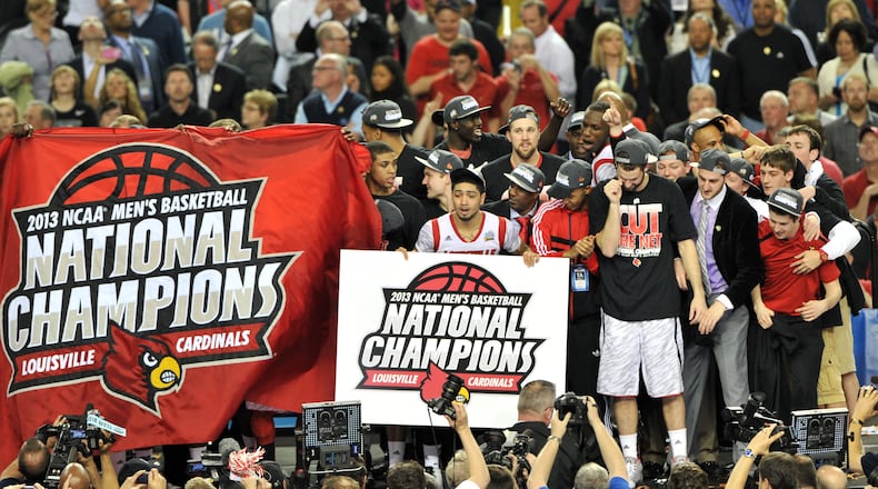 Louisville Cardinals players and fans celebrate the victory over  Michigan in the NCAAA Final Four championship game at the Georgia Dome on April 8, 2013. The victory has been vacated by the NCAA.
