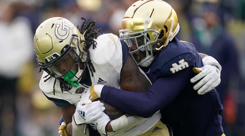Georgia Tech's Jahmyr Gibbs (1) is tackled by Notre Dame's Clarence Lewis (6) during the first half of an NCAA college football game, Saturday, Nov. 20, 2021, in South Bend, Ind. (AP Photo/Darron Cummings)