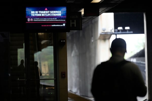 An electronic display advises commuters of NJ Transit service disruptions at the Secaucus Junction station in Secaucus, N.J., Wednesday, May 14, 2025. (AP Photo/Seth Wenig)