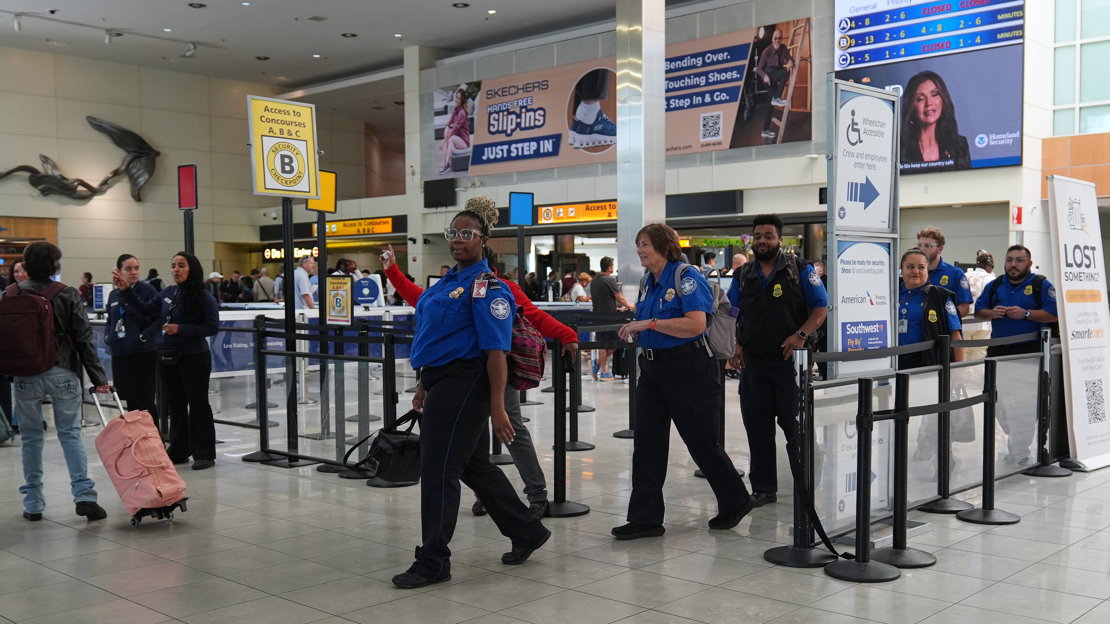 Transportation Security Administration employees leave a security checkpoint during a shift change at Baltimore/Washington International Thurgood Marshall Airport, Thursday, Oct. 2, 2025, in Baltimore. (AP Photo/Stephanie Scarbrough)