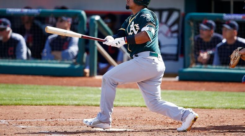 Oakland Athletics' Franklin Barreto watches the flight of his triple against the Cleveland Indians during the third inning of a spring training baseball game Tuesday, Feb. 27, 2018, in Goodyear, Ariz. The Indians defeated the Athletics 16-8. (AP Photo/Ross D. Franklin)