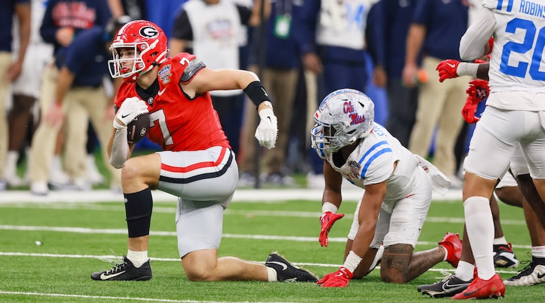 Georgia tight end Lawson Luckie (left) — pictured during the College Football Playoff game against Ole Miss in January — is one of seven Bulldogs who will have an extra year to play in college, should they so choose, under the new "5-in-5." (Jason Getz/AJC 2026)