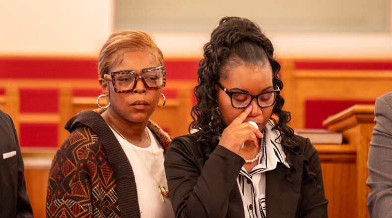 Rashunda McClendon (right) stands at press conference regarding the death of her daughter Jada West, following a fight at a bus stop. Monday, March 16, 2026 (Ben Hendren for the AJC)