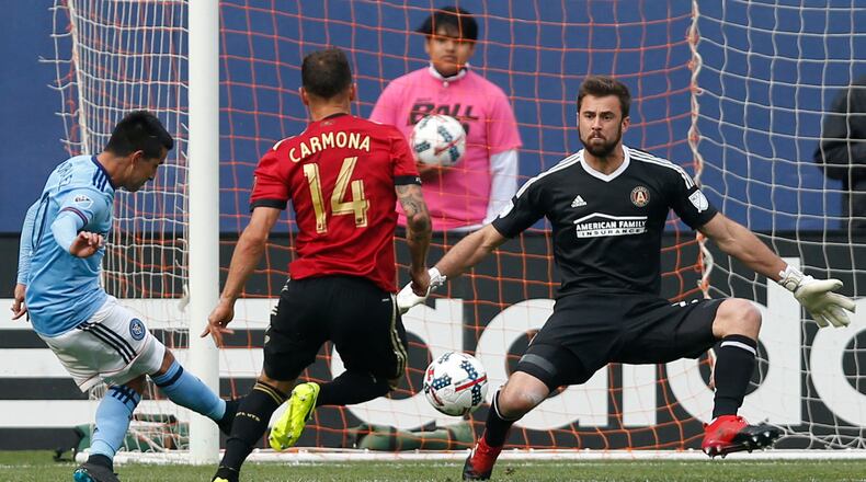 New York City FC midfielder Maximiliano Moralez (10), of Argentina, kicks a goal with Atlanta United midfielder Carlos Carmona (14) defending that Atlanta United goalkeeper Alec Kann (25) failed to stop during the second half of an MLS soccer game, Sunday, May 7, 2017, in New York. New York City FC defeated Atlanta United 3-1. (AP Photo/Kathy Willens)