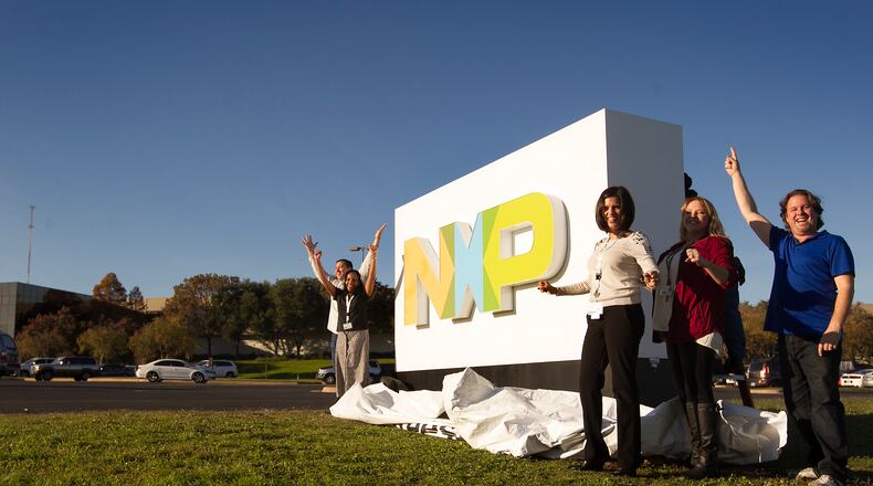 On Monday, Austin's Freescale Semiconductor officially became part of Dutch chipmaker NXP Semiconductors, as the companies complete the $11.9 billion deal. The company held a gathering for employees at the Austin campus and unveiled a new sign. From left on side closest to camera are Damaris Ochoa, Jill Brown, and William Foster. 
LAURA SKELDING/AMERICAN-STATESMAN