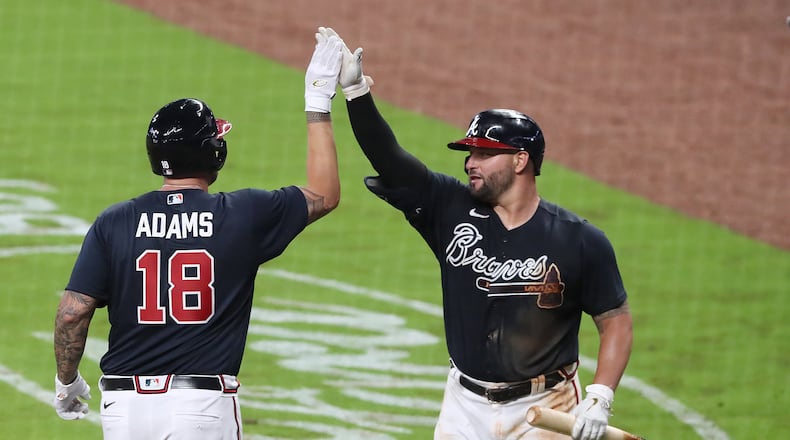 Welcome back, Matt Adams: Yonder Alonso greets the new Brave Adams following his home run that put a pin in Tuesday night's exhibition game against the Miami Marlins. Curtis Compton ccompton@ajc.com