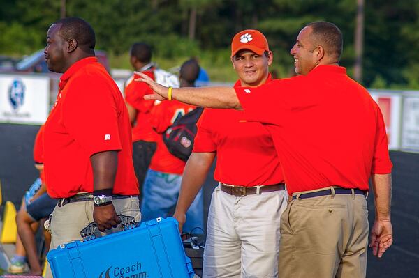 Mike Macdonald (center), who grew up in Roswell, got his coaching career start at Cedar Shoals. (Courtesy of Cedar Shoals Athletics)