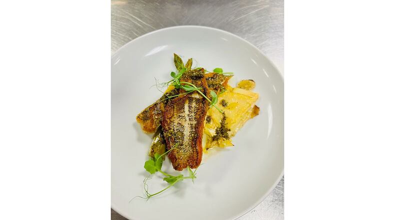 One of the new items on the menu at Chef Winnie's in Clarkston is the pan-roasted blackened mahi-mahi with potato cake and asparagus topped with chimichurri sauce. / Courtesy of Chef Winnie's