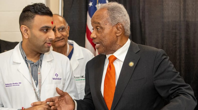U.S. Rep. David Scott hosts his annual health fair on Saturday, Aug. 16, 2025, where he meets Wellstar Dr. Rakendu Shukla at Rockdale County High School in Conyers. (Jenni Girtman for the AJC)