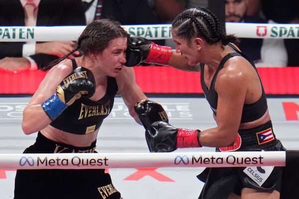 FILE - Amanda Serrano hits Katie Taylor during their undisputed super lightweight title bout, Friday, Nov. 15, 2024, in Arlington, Texas. (AP Photo/Julio Cortez, File)