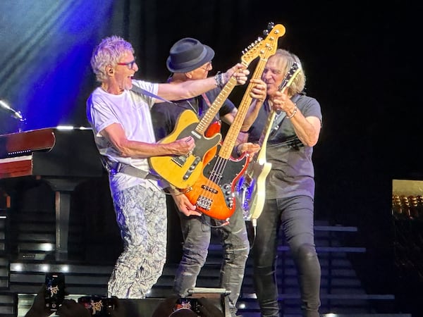 Kevin Cronin (from left) with his bassist Matt Bissonette and guitarist Dave Amato as part of his Kevin Cronin Band. Cronin can no longer use the name REO Speedwagon even though he was the long-time lead singer. (Rodney Ho/AJC)