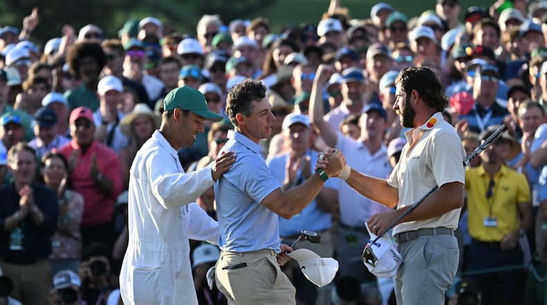 Rory McIlroy and caddie Harry Diamond greet Cameron Young at the end pf the final round of the Masters, at Augusta National Golf Club, Sunday, April 12, 2026, in Augusta, GA (Hyosub Shin/AJC)