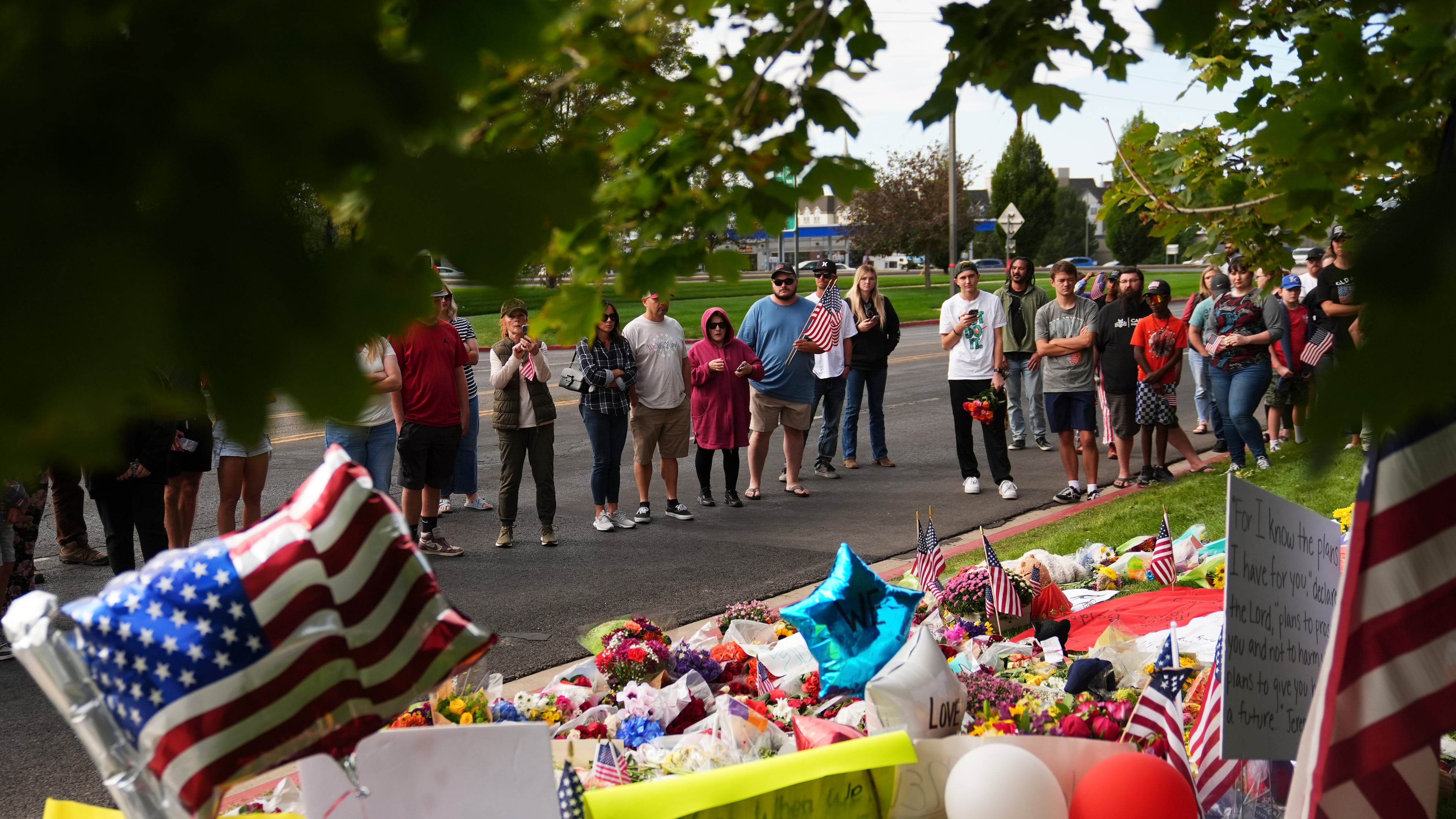 Supporters gather at a makeshift memorial in Orem, Utah, Saturday, Sept. 13, 2025, at Utah Valley University for Turning Point USA CEO and co-founder Charlie Kirk who was fatally shot during an event on the campus. (AP Photo/Lindsey Wasson)