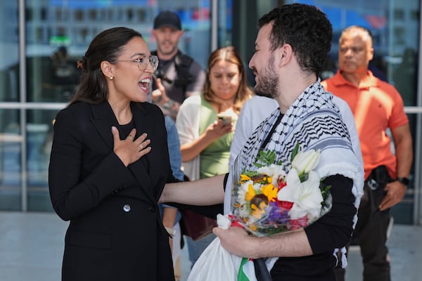 Mahmoud Khalil, right, speaks to Rep. Alexandria Ocasio-Cortez, D-N.Y., after arriving at Newark International Airport, Saturday, June 21, 2025, in Newark, N.J. (AP Photo/Seth Wenig)