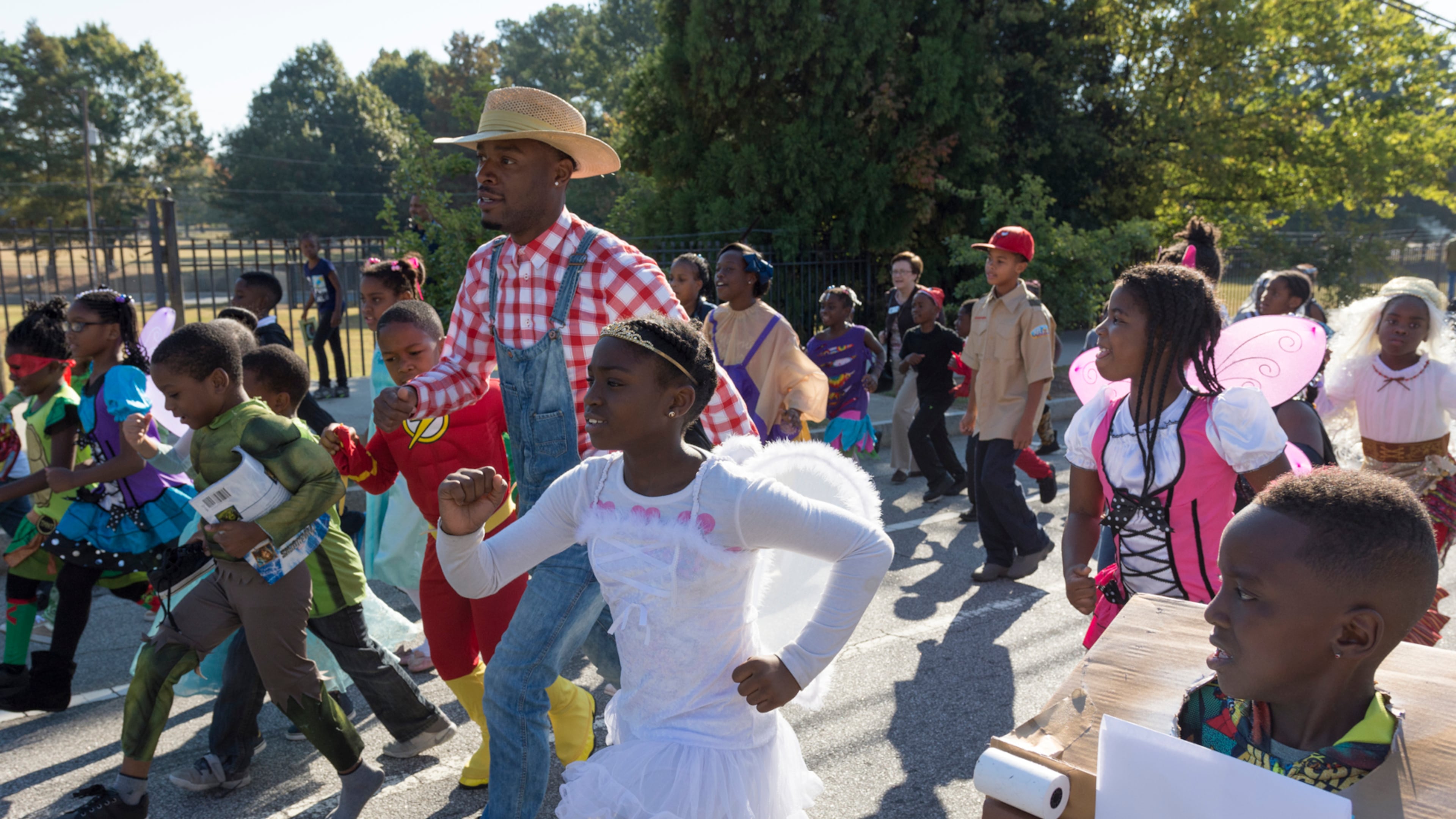 Jared Hill, a second grade teacher at Dunbar Elementary School, leads students in the annual Storybook Character Parade. The parade features students and faculty dressed in costume. (File/AJC 2016)