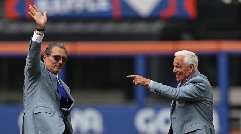 Lee Mazzilli, left, and Bobby Valentine wave and gesture during an induction ceremony into the New York Mets hall of fame before a baseball game against the Miami Marlins, Saturday, May 30, 2026, in New York. (AP Photo/Adam Hunger)