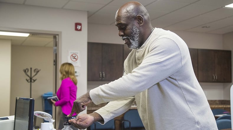 Dacula resident Denis Haynes Jr. uses hand sanitizer after casting his paper ballot during a special election for city council at Dacula City Hall in Dacula, Wednesday, March, 18, 2020. Haynes Jr. was running in this special race but withdrew his candidacy. (ALYSSA POINTER/ALYSSA.POINTER@AJC.COM)
