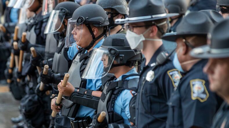 05/29/2020 - Atlanta, Georgia - Georgia State Police Patrolmen form a human barricade to push protestors back from the CNN Center following a peaceful protest march that turned violent in Atlanta, Friday, May 29, 2020. (ALYSSA POINTER / ALYSSA.POINTER@AJC.COM)