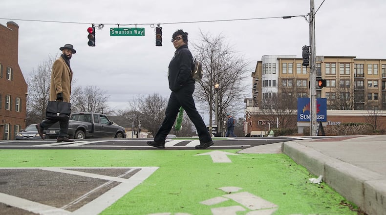 Pedestrians cross the intersection of Commerce Drive and Swanton Way in downtown Decatur, Thursday, January 23, 2020. The city renovated the sidewalks adding enough space for a bicycle lane in addition to foot traffic. (ALYSSA POINTER/ALYSSA.POINTER@AJC.COM)