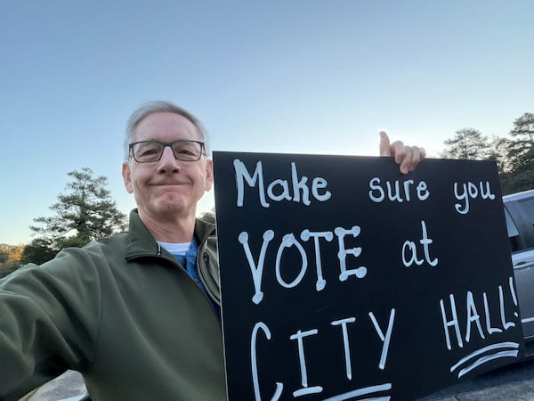 Randy Travis stood near his opponent Austin Thompson on Election Day trying to get people to vote at Lawrenceville City Hall Nov. 4, 2025. (Contributed)