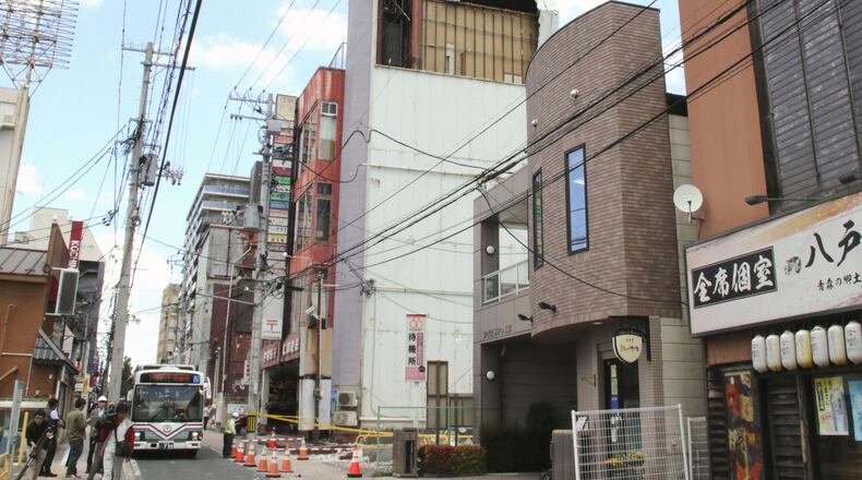 The wall of a building is seen partly damaged following an earthquake in Hachinohe, Aomori prefecture northern Japan, Thursday, June 25, 2026. (Kyodo News via AP)