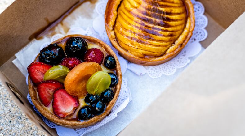 Two tarts available from Saint Germain French Bakery in Ponce City Market are mixed fruit (left) and apple and almond (right). Henri Hollis for The Atlanta Journal-Constitution.