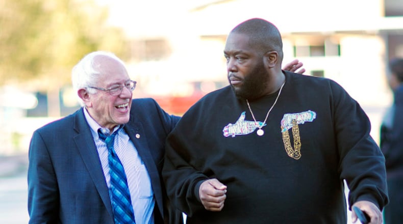 Sen. Bernie Sanders, I-Vt. left, walks in with rapper Killer Mike for a visit to the Busy Bee Café in Atlanta.