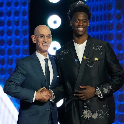 AJ Dybantsa, right, poses for a photo with NBA commissioner Adam Silver, left, after being selected by the Washington Wizards as the first pick in the first round of the NBA basketball draft, Tuesday, June 23, 2026, in New York. (AP Photo/Yuki Iwamura)