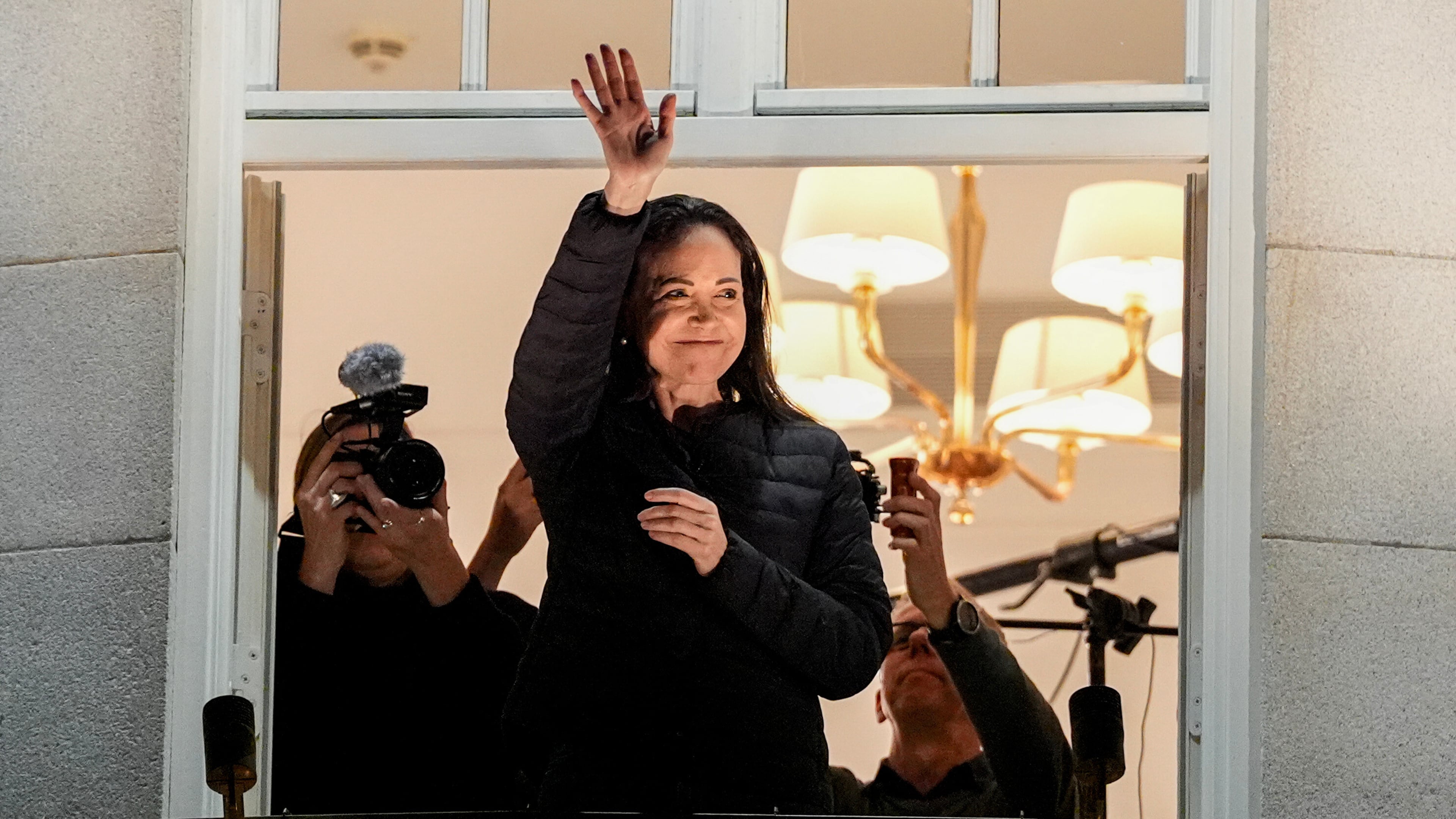 Nobel Peace Prize laureate Maria Corina Machado waves at the Grand Hotel in Oslo, Norway, early Thursday, Dec. 11, 2025. (Lise Åserud/NTB Scanpix via AP)