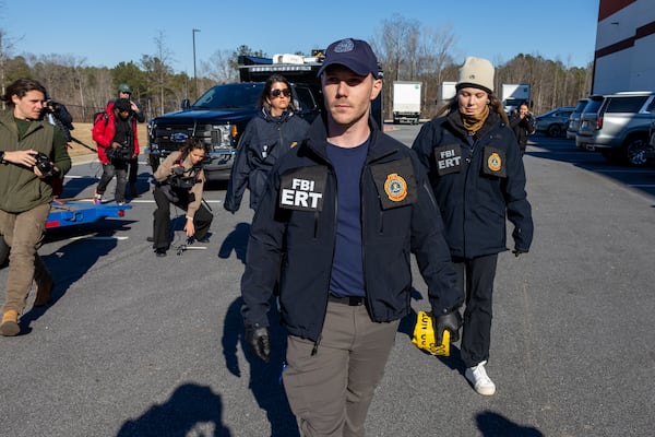 FBI evidence response team members appeared at the at Fulton County Election Hub and Operation Center in Union City on Wednesday. (Arvin Temkar/AJC)