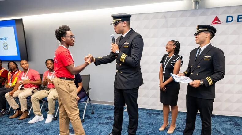 Delta Air Lines Pilot Justin Mutawassim shakes hands with a student during an ACE and Solo Flight Academy event. (Photo Courtesy of Delta Air Lines)