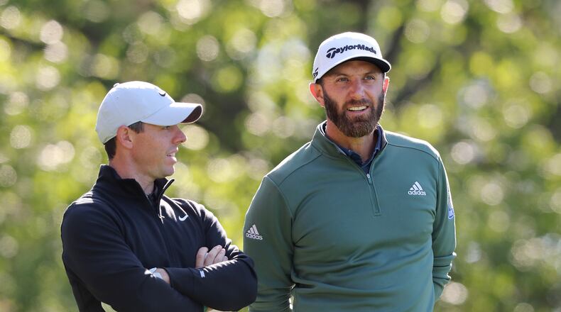 Rory McIIroy (left) and Dustin Johnson confer on the fourth tee during their practice round for the Masters at Augusta National Golf Club on Monday, April 5, 2021, in Augusta.  Curtis Compton / Curtis.Compton@ajc.com