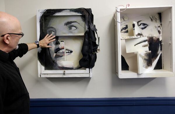 In this Monday, May 8, 2017 photo artist Richard Neal, of Centerville, Mass., left, talks about his multi-media constructions called "Jackie," center, and "Jack," right, at the John F. Kennedy Hyannis Museum in Hyannis, Mass. The art objects were created from household objects and construction materials removed during a recent renovation of John F. Kennedy's summer home. The items removed from the house were preserved and offered to Cape Cod artists who in turn fashioned them into artwork. (AP Photo/Steven Senne)
