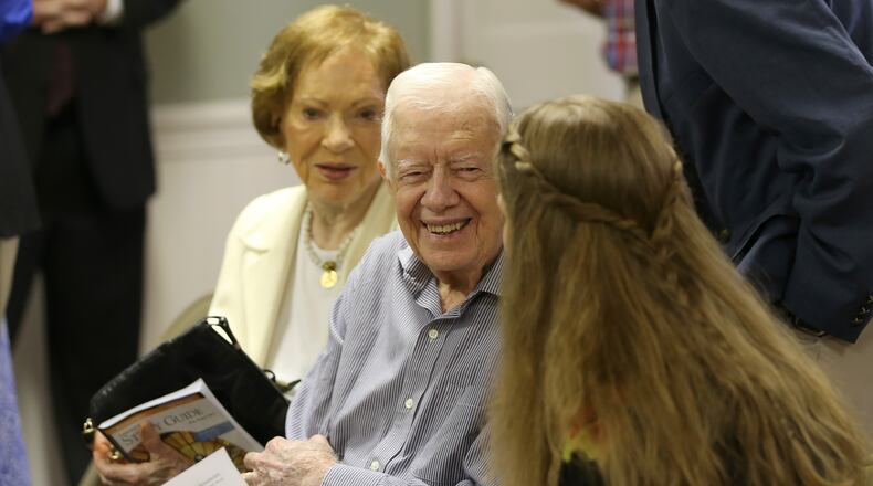 August 16, 2015 Plains: Former President Jimmy Carter talks with neighbor Stephanie Wynn before the start of bible study at Maranatha Baptist Church in Plains on Sunday morning August 16, 2015. Sunday at church was emotional because it was the first time many people had seen Carter since his announcement that he has cancer. Ben Gray / bgray@ajc.com