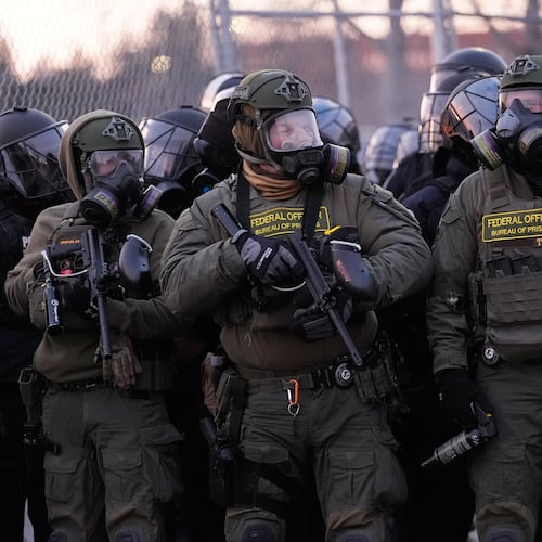 Federal officers stand outside the Bishop Henry Whipple Federal Building during a protest on Saturday, Jan. 17, 2026, in Minneapolis. (AP Photo/Yuki Iwamura)